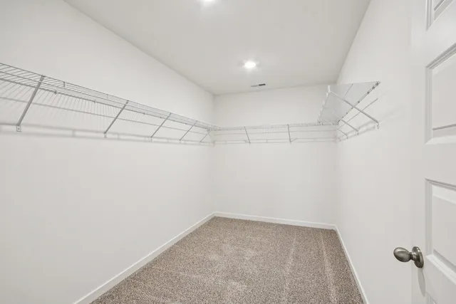 a spacious bedroom with a bed and a couch