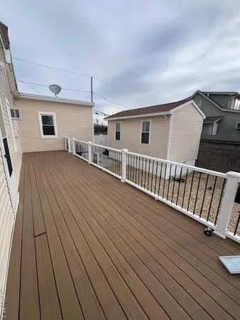 a view of a house with wooden deck