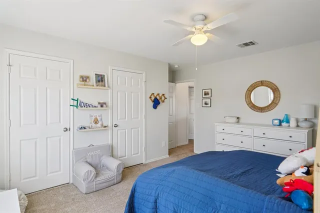 a bedroom with a bed and a couch