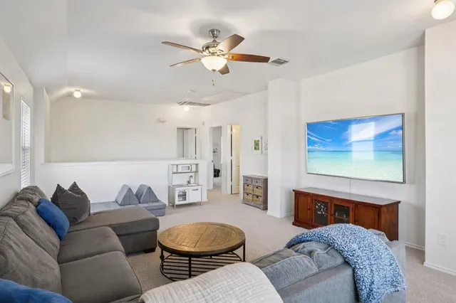 a spacious bedroom with a bed and a chandelier