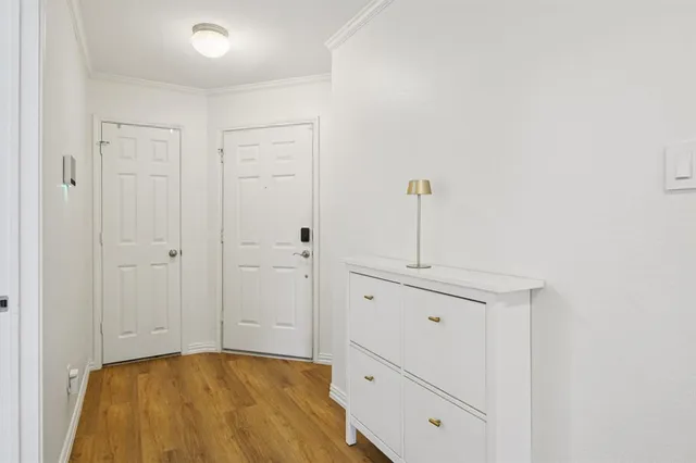 a bedroom with a bed and large windows