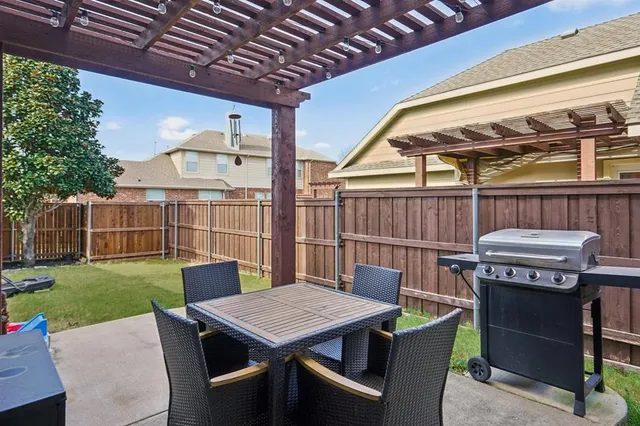 a view of a patio with a table and chairs