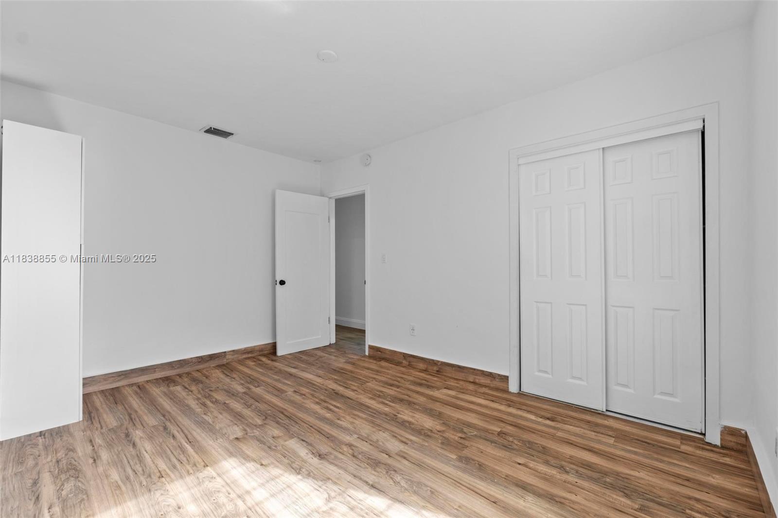 738 Fernwood Road Key Biscayne, FL 33149 - Photo 17 of 43 a view of a room with wooden floor