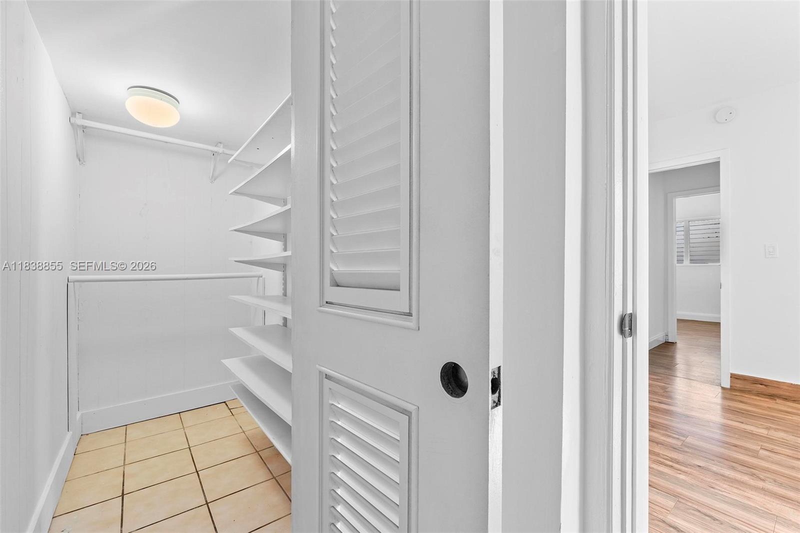 738 Fernwood Road Key Biscayne, FL 33149 - Photo 25 of 39 a view of a hallway with wooden floor and staircase