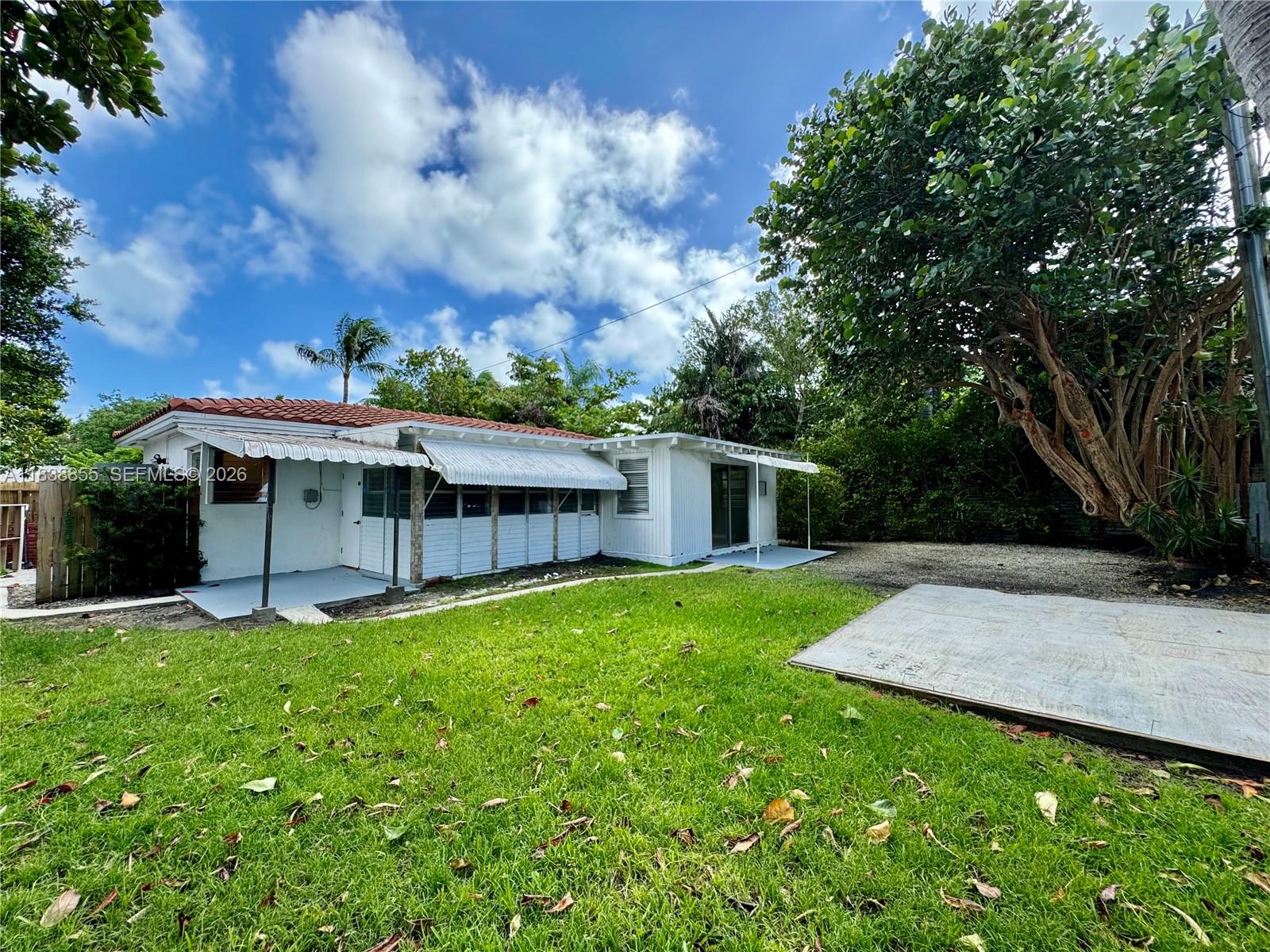 738 Fernwood Road Key Biscayne, FL 33149 - Photo 33 of 39 a view of a house with a yard and sitting area