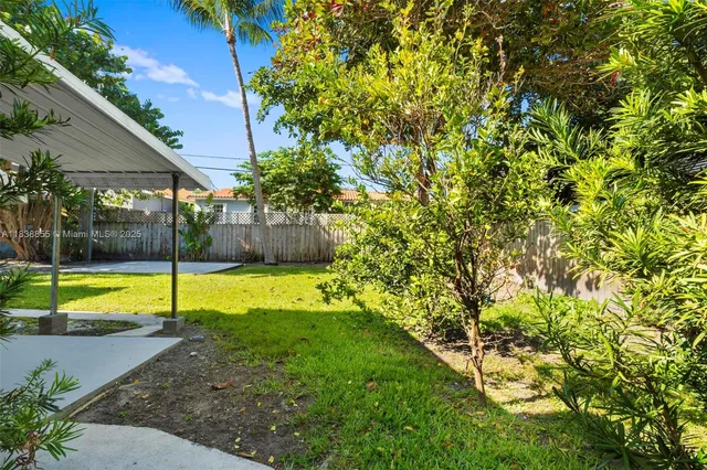 a view of a backyard with swimming pool