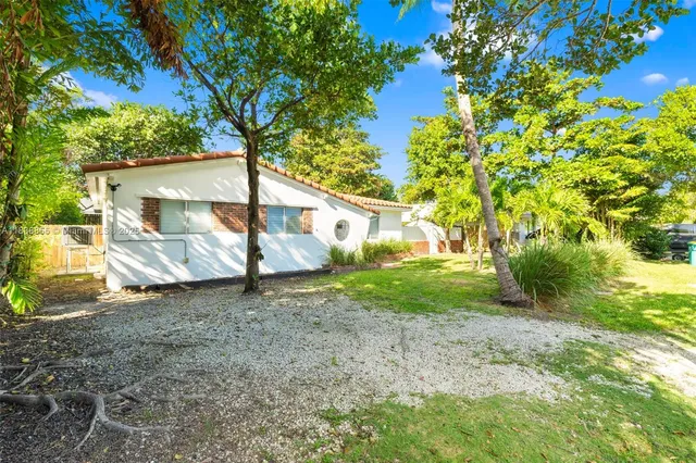 a view of a house with a tree