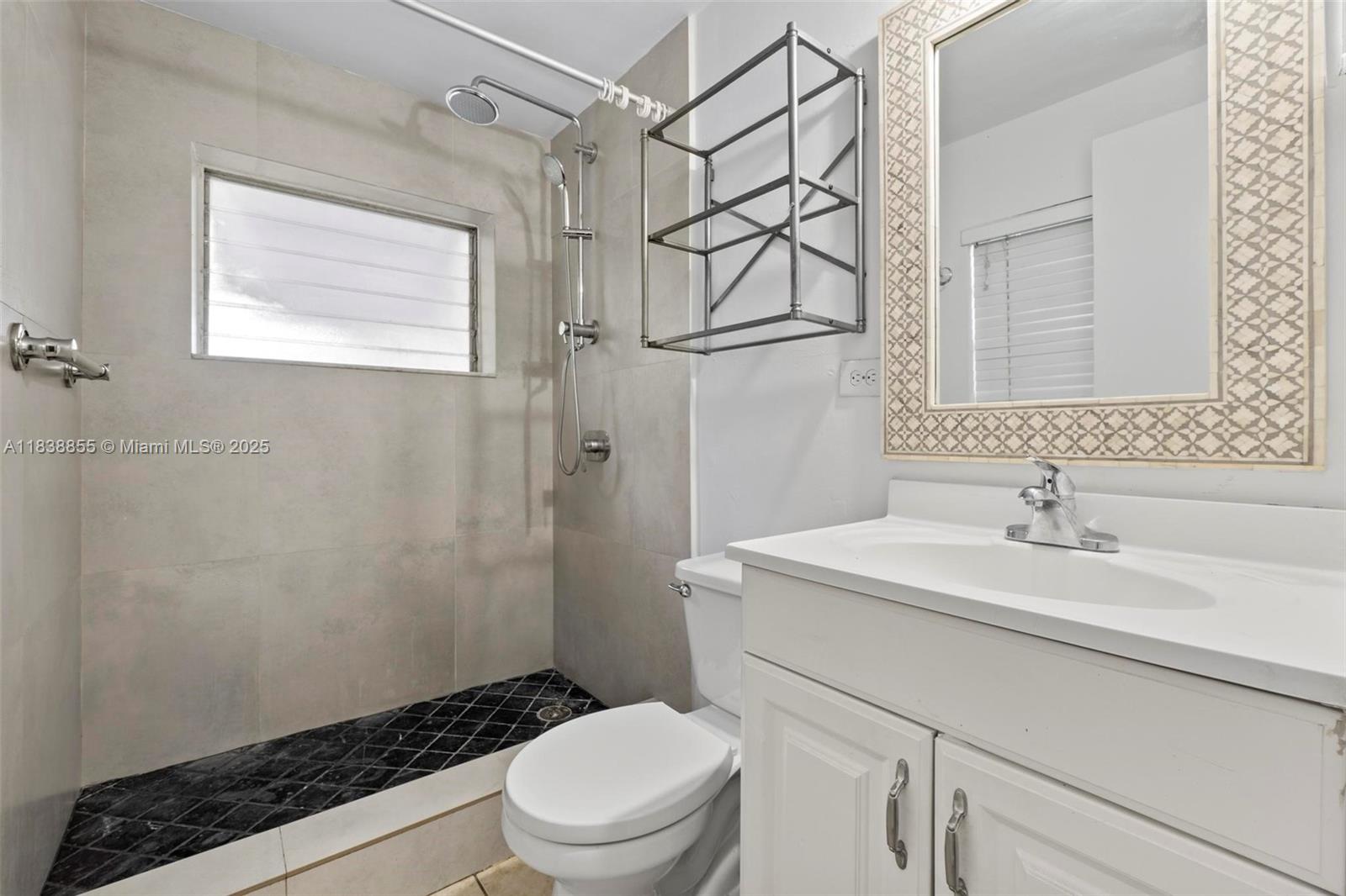 738 Fernwood Road Key Biscayne, FL 33149 - Photo 42 of 43 a bathroom with a sink toilet vanity and shower