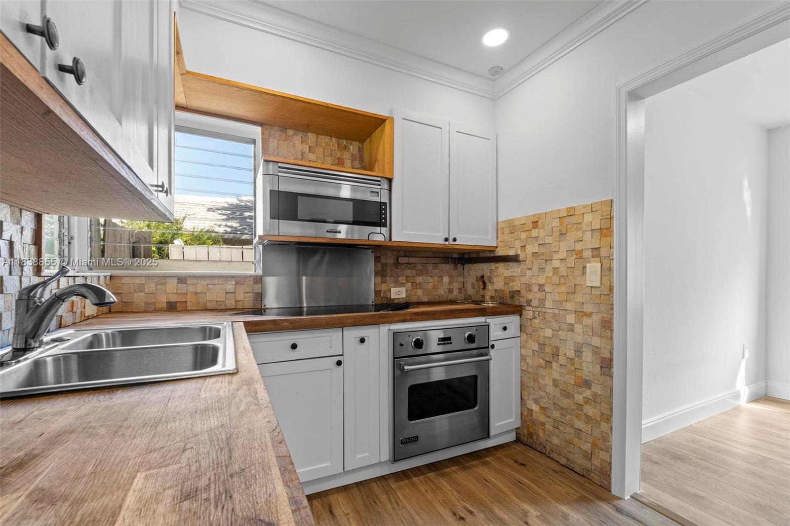 738 Fernwood Road Key Biscayne, FL 33149 - Photo 6 of 43 a kitchen with stainless steel appliances granite countertop a sink and a stove