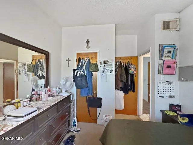 a view of a big room with windows and chandelier fan