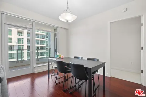 a view of a room with wooden floor and a window
