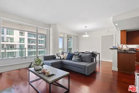 a living room with furniture and a kitchen view
