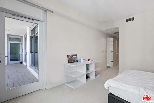 a bedroom with a bed and a desk