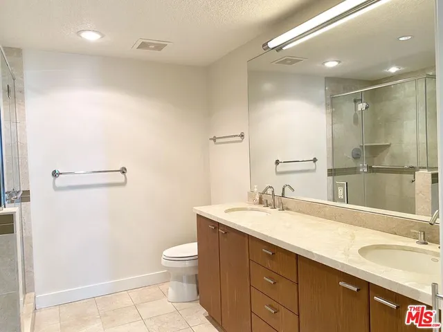 a bedroom with two beds and a desk