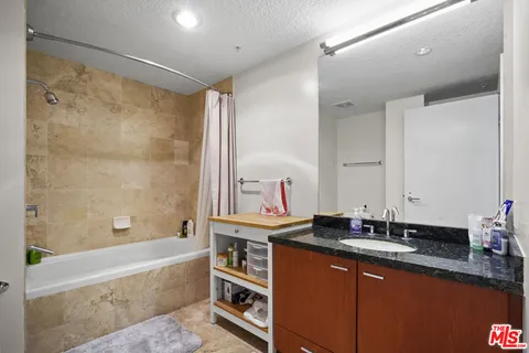 an aerial view of a residential building with swimming pool and ocean view