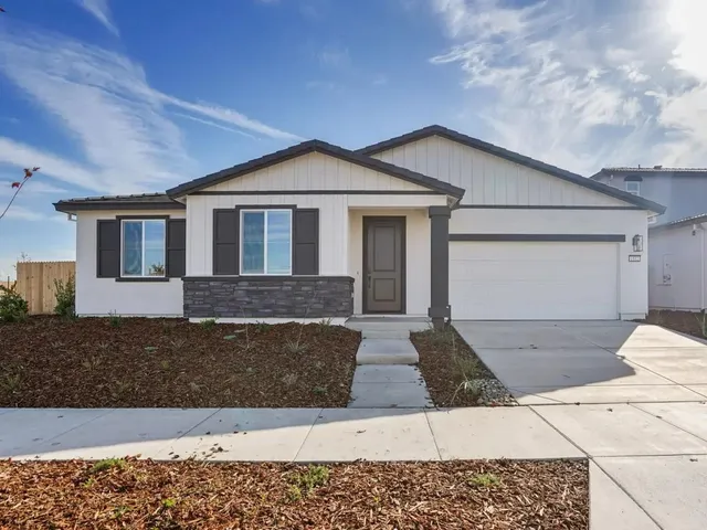 a front view of a house with yard
