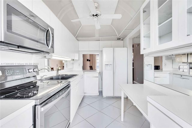 a kitchen with stainless steel appliances a sink stove and refrigerator