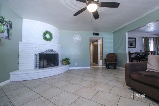 221 South Primrose Street Ridgecrest, CA 93555 - Photo 6 of 29 a living room with furniture and a fireplace