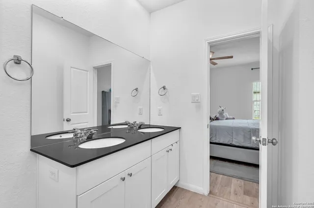 a en suite bathroom with 2 sink and a mirror