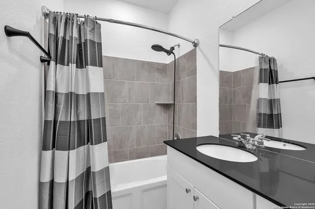 a bathroom with a sink and a shower