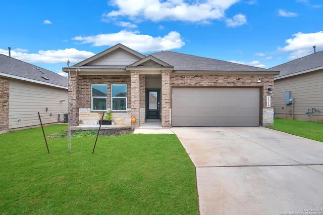 a front view of house with a garden and patio
