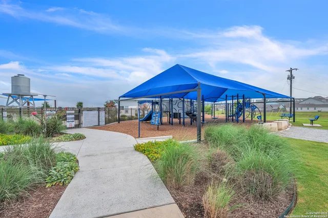 a view of a table and chairs under an umbrella