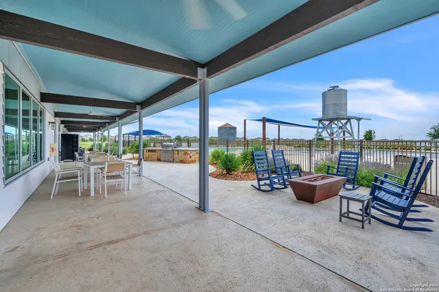 a view of a patio with chairs and plants