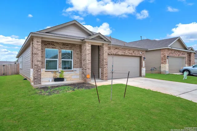 a view of a house with a yard and sitting area