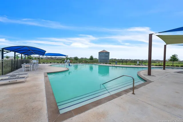 a view of a lake with a floor to ceiling window next to a yard