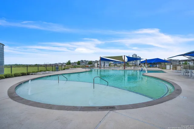 a view of a swimming pool with a yard