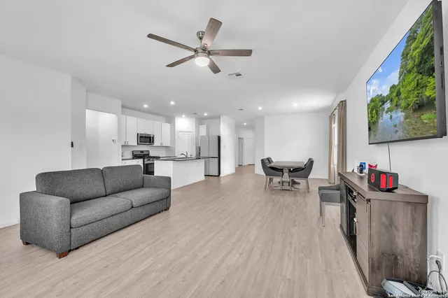 a living room with furniture and kitchen view