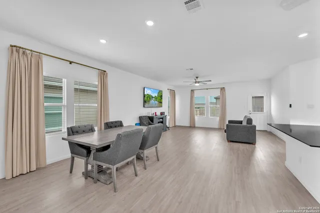 a view of a dining room with furniture and wooden floor