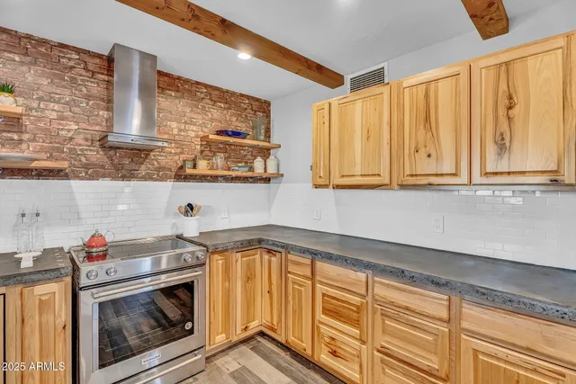 a view of a kitchen with wooden floor and electronic appliances