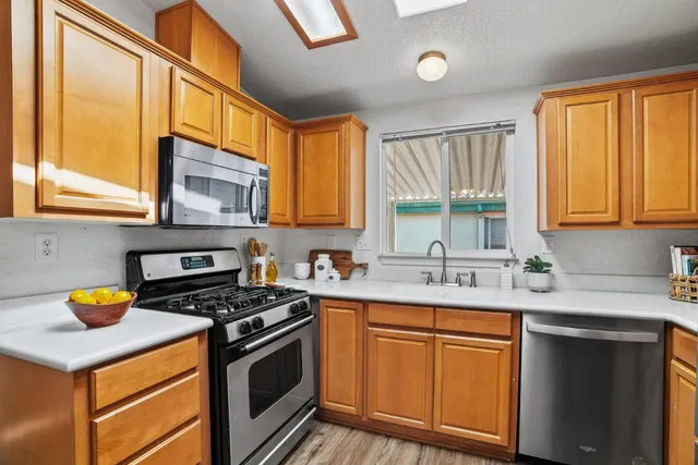 a kitchen with a sink stove top oven and cabinets