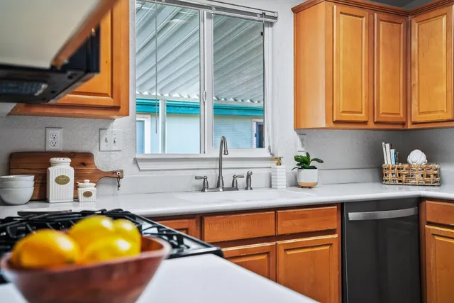 a kitchen with a sink a counter and a cabinets
