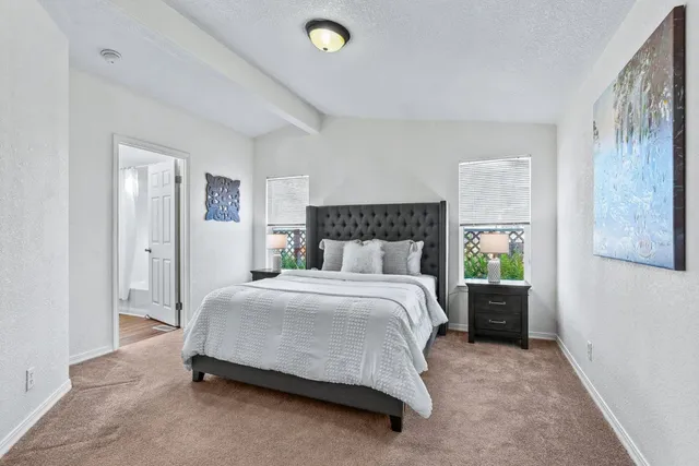 a spacious bedroom with a bed and a window