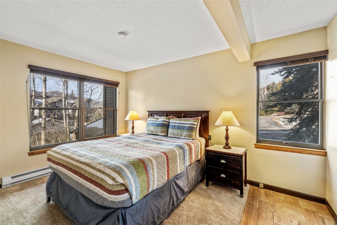 2015 Walton Creek Road, Unit 105 Steamboat Springs, CO 80487 - Photo 12 of 34 a bedroom with a bed and a large window