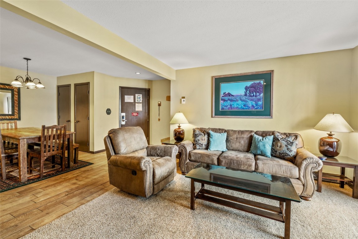 2015 Walton Creek Road, Unit 105 Steamboat Springs, CO 80487 - Photo 2 of 34 a living room with furniture a dining table and a piano table