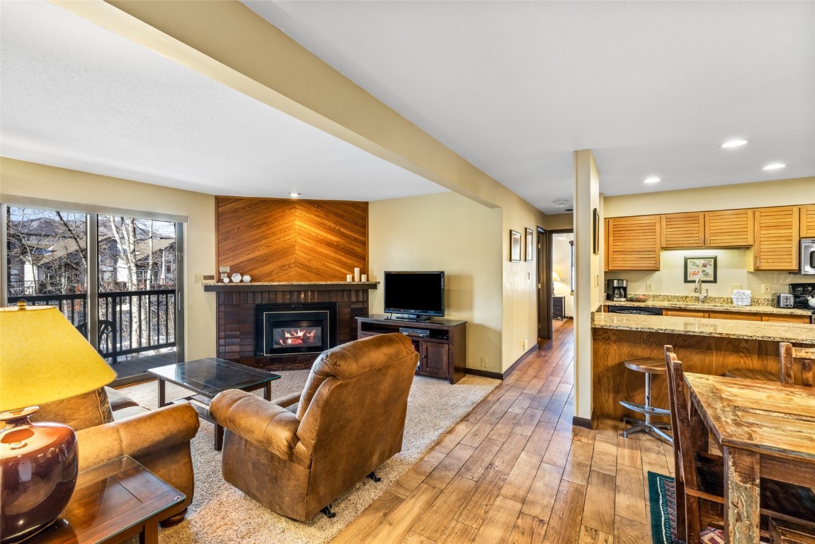 2015 Walton Creek Road, Unit 105 Steamboat Springs, CO 80487 - Photo 3 of 34 a living room with fireplace furniture and a flat screen tv