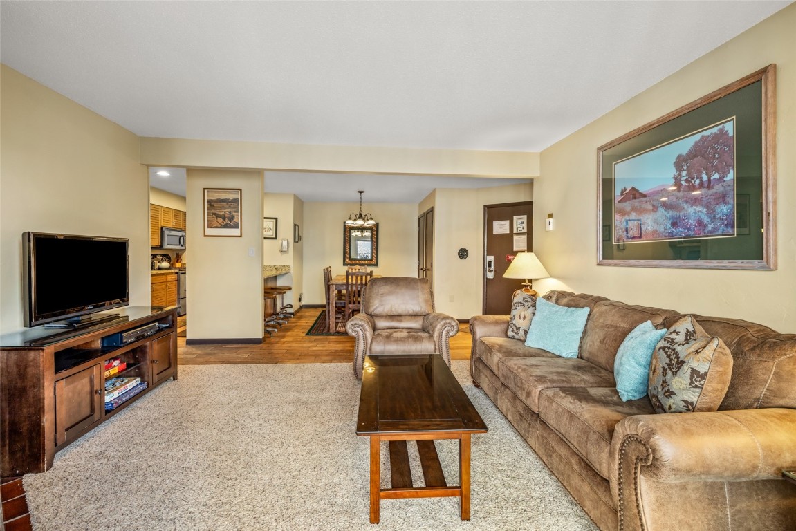2015 Walton Creek Road, Unit 105 Steamboat Springs, CO 80487 - Photo 5 of 34 a living room with furniture and a flat screen tv