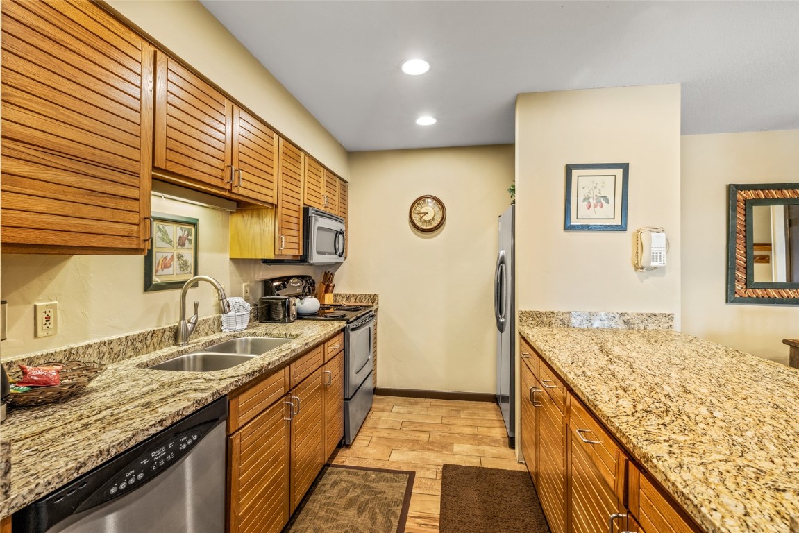 2015 Walton Creek Road, Unit 105 Steamboat Springs, CO 80487 - Photo 8 of 34 a bathroom with a granite countertop sink and a mirror