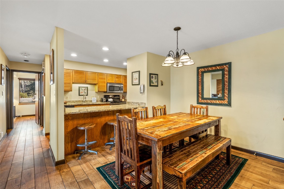 2015 Walton Creek Road, Unit 105 Steamboat Springs, CO 80487 - Photo 10 of 34 a view of a dining room with furniture window and wooden floor