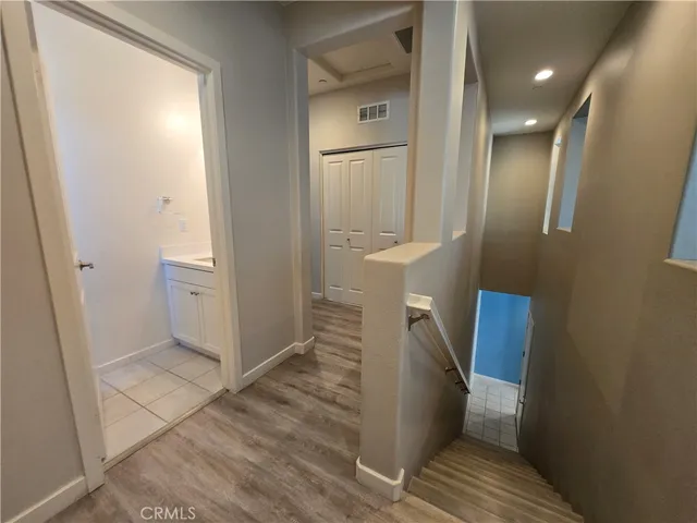 a view of a hallway with wooden floor