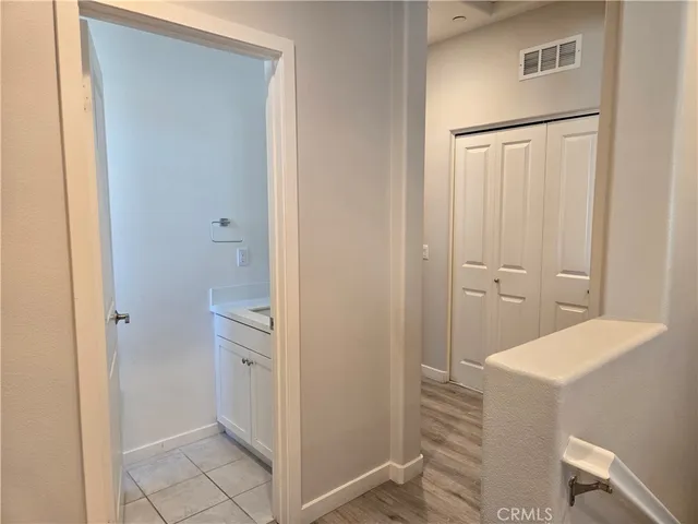 a view of empty room with window and wooden floor