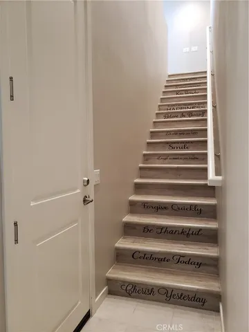 a view of kitchen with stainless steel appliances kitchen island wooden floor and window