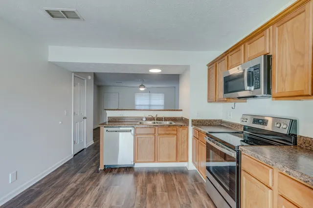 a kitchen with stainless steel appliances granite countertop a stove and a sink