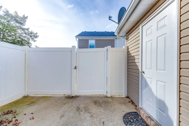 a view of a house with a wooden fence