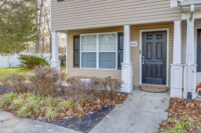 front view of a brick house with a small yard
