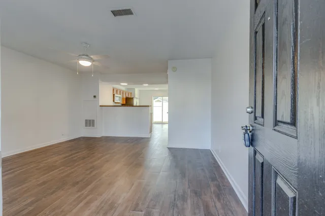 a view of a kitchen with wooden floor and a sink