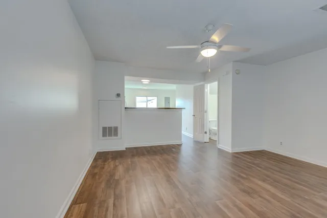 wooden floor in an empty room with a window